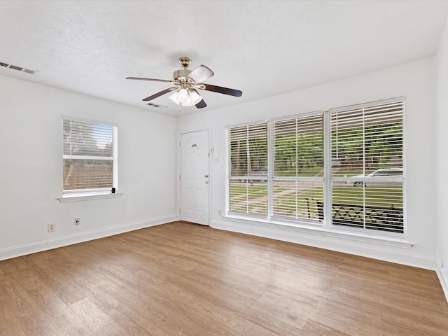 511 Wildwood Dr, Mesquite, TX 75149 - spare room featuring wood finished floors, ceiling fan, and baseboards