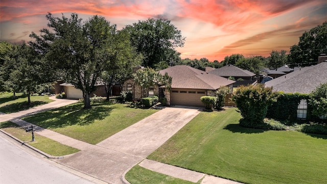 view of front facade with a garage, a yard, and driveway