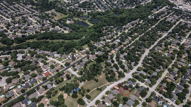 aerial view of property and surrounding area featuring a large body of water