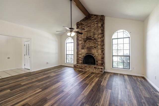 unfurnished living room featuring wood finished floors, plenty of natural light, ceiling fan, and a fireplace