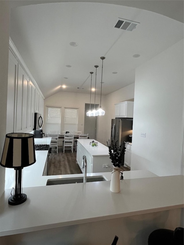 1812 Horseshoe Ln, Van Alstyne, TX 75495 - kitchen featuring a center island, white cabinets, vaulted ceiling, decorative light fixtures, and a sink