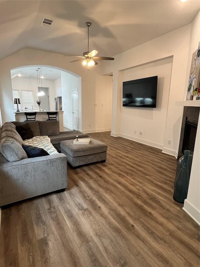 1812 Horseshoe Ln, Van Alstyne, TX 75495 - living room featuring arched walkways, ceiling fan, dark wood-style flooring, baseboards, and lofted ceiling