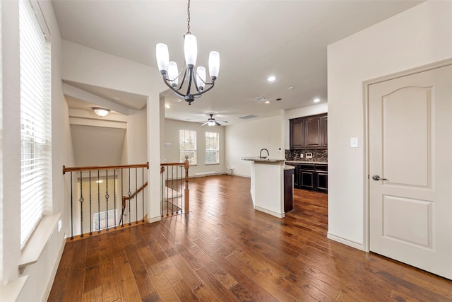 7941 Parkwood Blvd, Plano, TX 75024 - kitchen with a chandelier, dark brown cabinets, recessed lighting, dark wood-type flooring, and backsplash