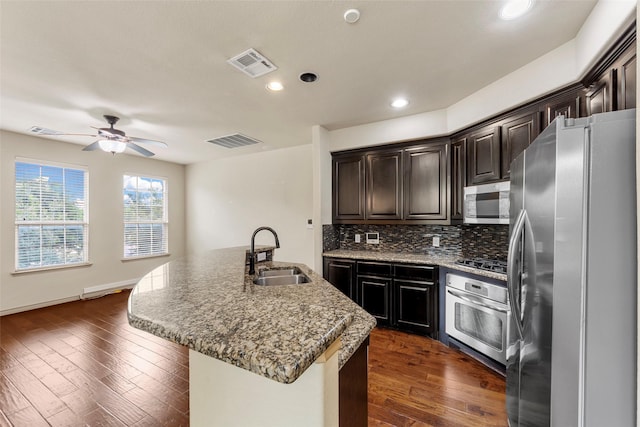 7941 Parkwood Blvd, Plano, TX 75024 - kitchen featuring stainless steel appliances, a sink, ceiling fan, backsplash, and recessed lighting