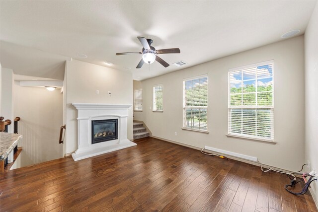 7941 Parkwood Blvd, Plano, TX 75024 - unfurnished living room with ceiling fan, hardwood / wood-style floors, a glass covered fireplace, and baseboards