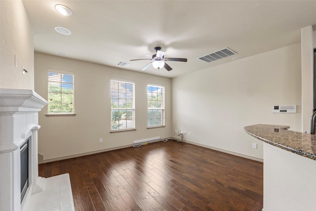 7941 Parkwood Blvd, Plano, TX 75024 - unfurnished living room with a fireplace with flush hearth, a ceiling fan, dark wood finished floors, and baseboards