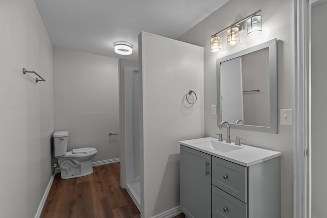 560 N Cardinal Rd, Reno, TX 76020 - bathroom featuring toilet, wood finished floors, baseboards, and vanity