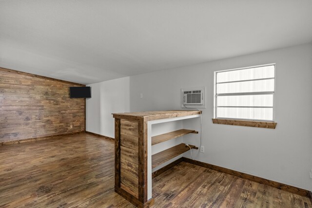 560 N Cardinal Rd, Reno, TX 76020 - spare room with wood finished floors, a wall unit AC, vaulted ceiling, wooden walls, and baseboards
