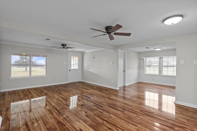 560 N Cardinal Rd, Reno, TX 76020 - unfurnished living room featuring ceiling fan, wood finished floors, plenty of natural light, and crown molding