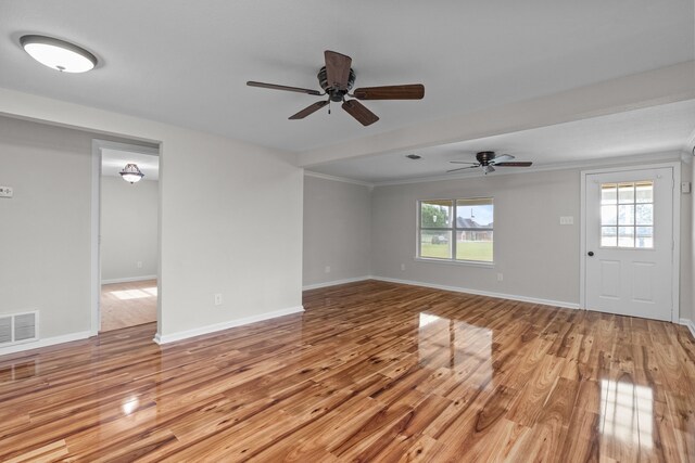 560 N Cardinal Rd, Reno, TX 76020 - unfurnished living room featuring light wood finished floors, ceiling fan, ornamental molding, and baseboards