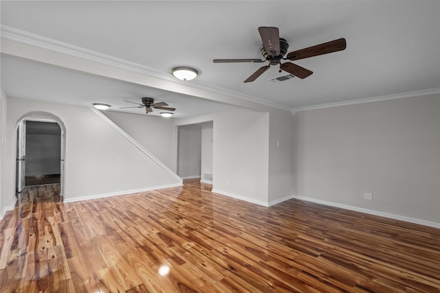 560 N Cardinal Rd, Reno, TX 76020 - unfurnished room with a ceiling fan, arched walkways, ornamental molding, wood finished floors, and baseboards