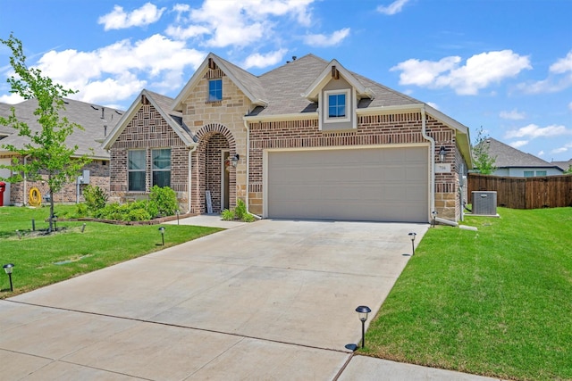 716 Newberry Ln, Royse City, TX 75189 - french country inspired facade with brick siding, concrete driveway, roof with shingles, an attached garage, and central AC