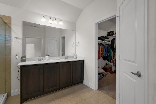 716 Newberry Ln, Royse City, TX 75189 - full bathroom featuring double vanity, a tile shower, tile patterned flooring, a walk in closet, and baseboards