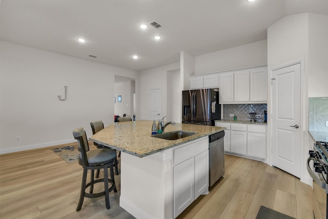 716 Newberry Ln, Royse City, TX 75189 - kitchen featuring black refrigerator with ice dispenser, dishwasher, a sink, gas stove, and light wood finished floors