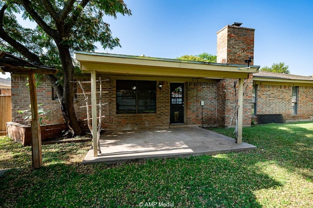 3226 Whitewing Way, Abilene, TX 79606 - rear view of property featuring a chimney, a lawn, brick siding, and a patio area