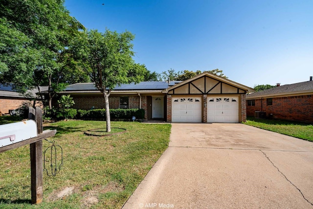 3226 Whitewing Way, Abilene, TX 79606 - view of front facade with an attached garage, a front lawn, solar panels, concrete driveway, and brick siding