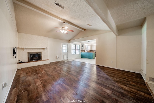 3226 Whitewing Way, Abilene, TX 79606 - unfurnished living room with wood finished floors, ceiling fan, a brick fireplace, baseboards, and a textured ceiling