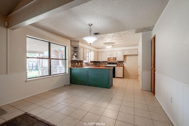 3226 Whitewing Way, Abilene, TX 79606 - kitchen featuring electric stove, a peninsula, a textured ceiling, light tile patterned floors, and open shelves