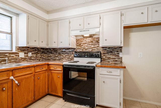 3226 Whitewing Way, Abilene, TX 79606 - kitchen featuring electric range, under cabinet range hood, light tile patterned floors, decorative backsplash, and a sink