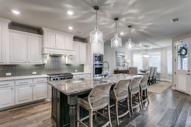1801 Wichita Dr, Prosper, TX 75078 - kitchen with stainless steel appliances, a kitchen bar, decorative backsplash, an island with sink, and recessed lighting