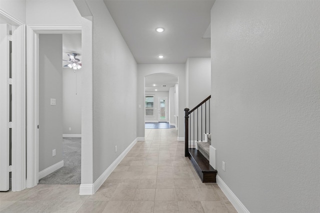 14824 Belclaire Ave, Aledo, TX 76008 - hallway with arched walkways, stairs, recessed lighting, baseboards, and light tile patterned floors