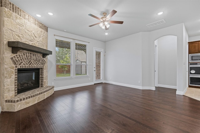 14824 Belclaire Ave, Aledo, TX 76008 - unfurnished living room with a fireplace, ceiling fan, arched walkways, baseboards, and wood finished floors
