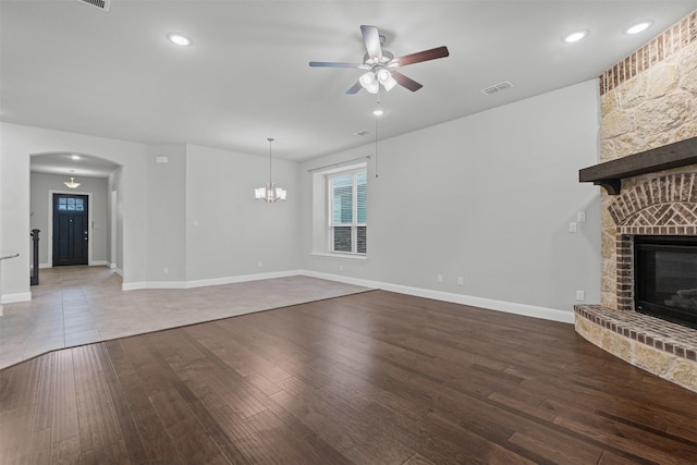 14824 Belclaire Ave, Aledo, TX 76008 - unfurnished living room featuring a large fireplace, ceiling fan, wood finished floors, arched walkways, and baseboards