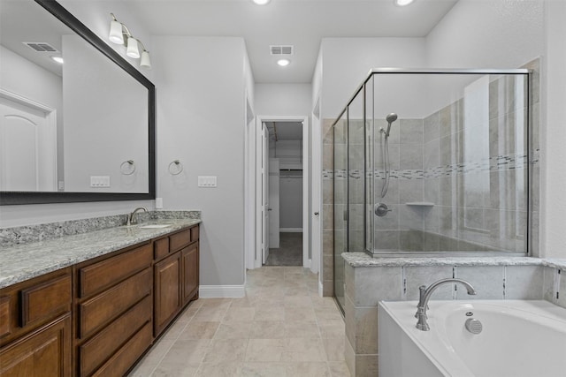 14824 Belclaire Ave, Aledo, TX 76008 - full bath featuring a shower stall, vanity, a garden tub, baseboards, and a spacious closet