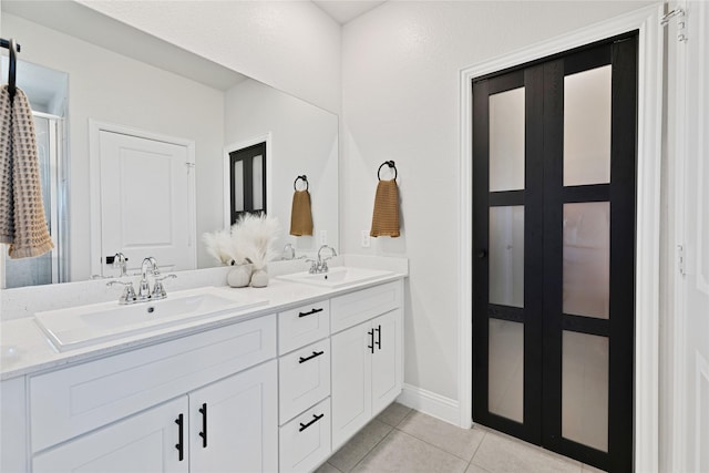 3708 Bennett Trl, Celina, TX 75009 - full bath featuring tile patterned floors, double vanity, a stall shower, and baseboards