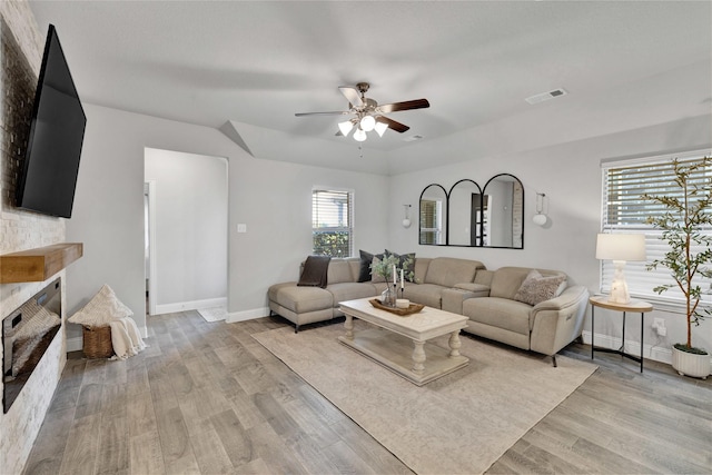 3708 Bennett Trl, Celina, TX 75009 - living room with ceiling fan, baseboards, light wood-style floors, and a fireplace with raised hearth