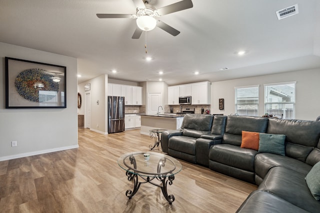 263 Hawthorn Dr, Lavon, TX 75166 - living room featuring light wood-style floors, baseboards, a ceiling fan, and recessed lighting