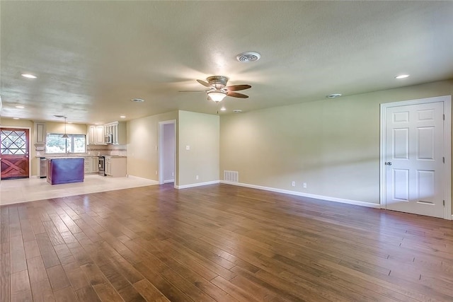 1200 County Road 701a, Cleburne, TX 76031 - unfurnished living room with ceiling fan, wood-type flooring, baseboards, and recessed lighting