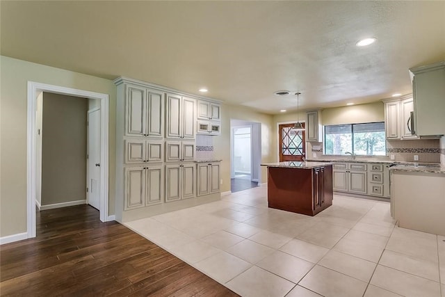 1200 County Road 701a, Cleburne, TX 76031 - kitchen featuring recessed lighting, a kitchen island, baseboards, decorative backsplash, and light wood-style flooring