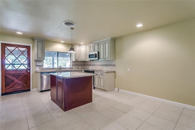 1200 County Road 701a, Cleburne, TX 76031 - kitchen with appliances with stainless steel finishes, decorative backsplash, recessed lighting, light stone counters, and hanging light fixtures