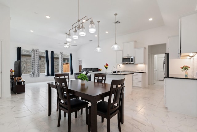 1309 Haybale Ln, Garland, TX 75042 - dining area featuring light marble finish flooring, a ceiling fan, and recessed lighting