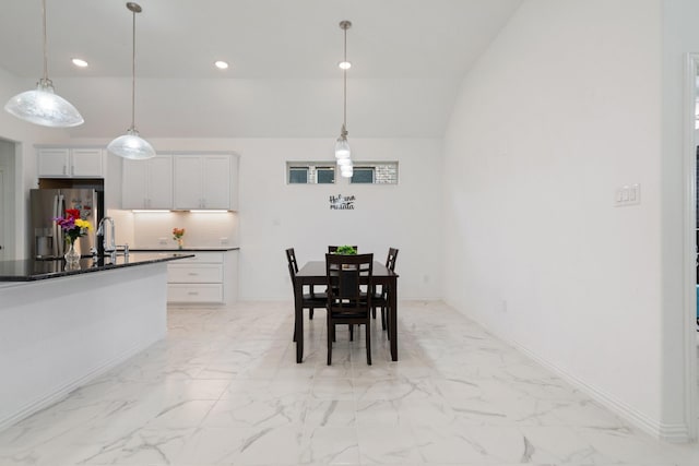 1309 Haybale Ln, Garland, TX 75042 - dining area with light marble finish flooring, recessed lighting, vaulted ceiling, and baseboards