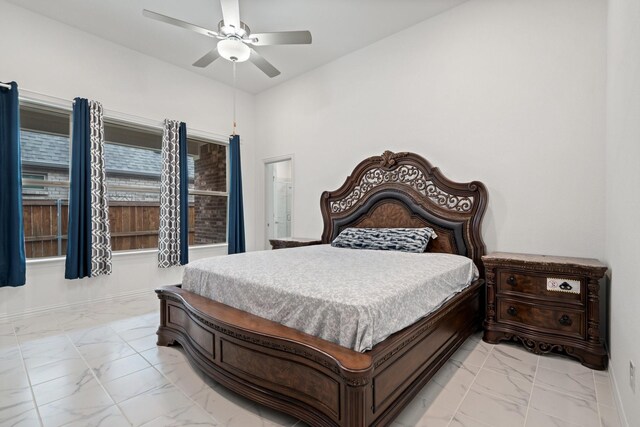 1309 Haybale Ln, Garland, TX 75042 - bedroom featuring light marble finish floors, ceiling fan, and baseboards