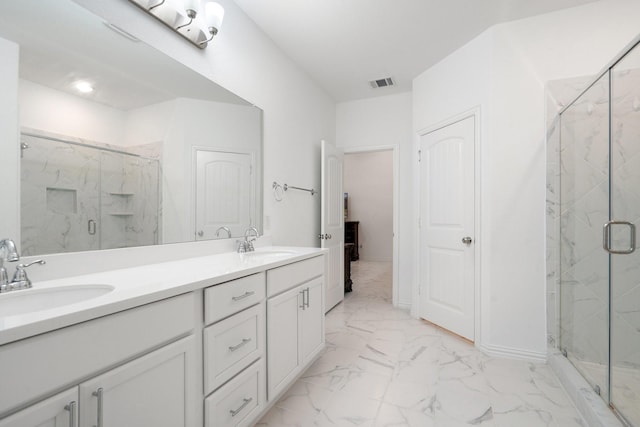 1309 Haybale Ln, Garland, TX 75042 - bathroom featuring marble finish floors, a marble finish shower, and double vanity