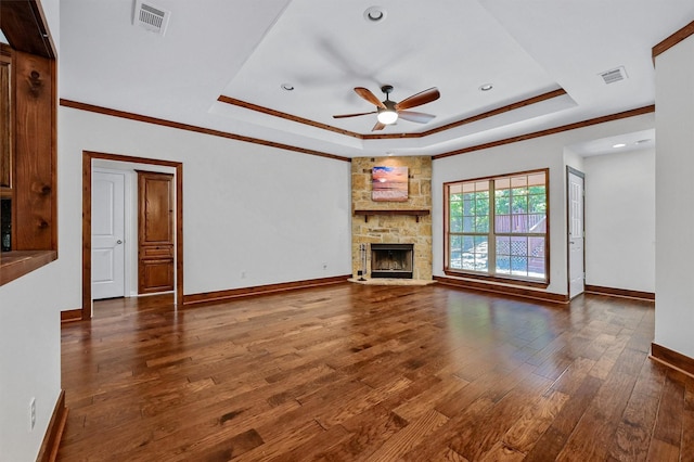118 Hacienda Dr, Pottsboro, TX 75076 - unfurnished living room featuring a raised ceiling, ceiling fan, hardwood / wood-style floors, a stone fireplace, and baseboards