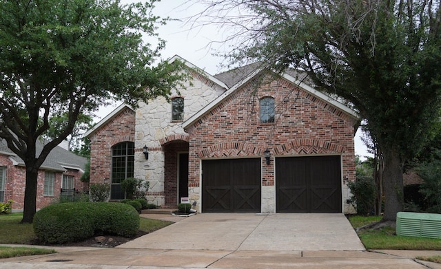 1136 Philip Dr, Allen, TX 75013 - view of front facade with concrete driveway, stone siding, brick siding, and an attached garage