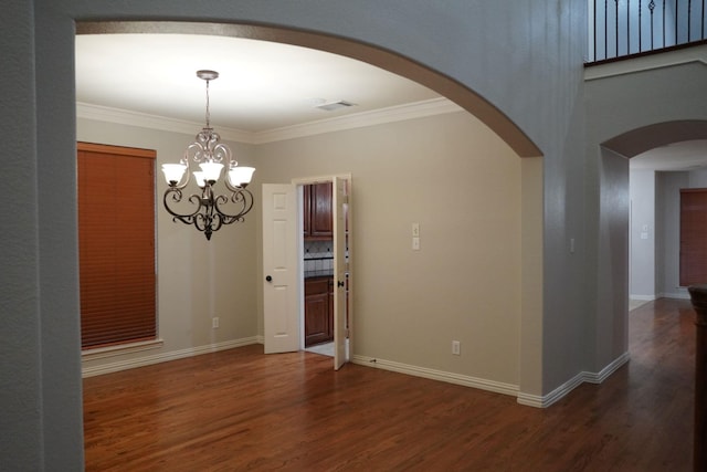 1136 Philip Dr, Allen, TX 75013 - spare room featuring arched walkways, dark wood finished floors, a chandelier, ornamental molding, and baseboards