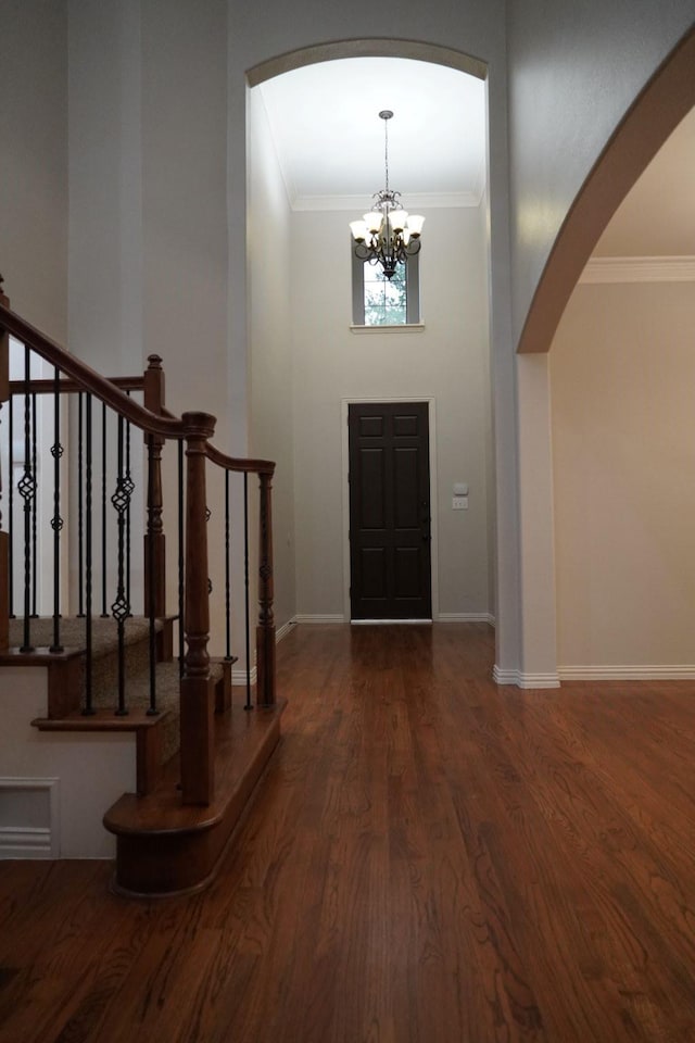 1136 Philip Dr, Allen, TX 75013 - entryway featuring arched walkways, a chandelier, wood finished floors, crown molding, and stairway