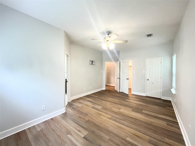 922 Mustang Dr, Allen, TX 75002 - unfurnished bedroom featuring wood finished floors, baseboards, and a ceiling fan