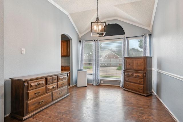 5729 Brazos Dr, Haltom City, TX 76137 - entryway featuring a chandelier, arched walkways, vaulted ceiling, a textured ceiling, and dark wood-style floors