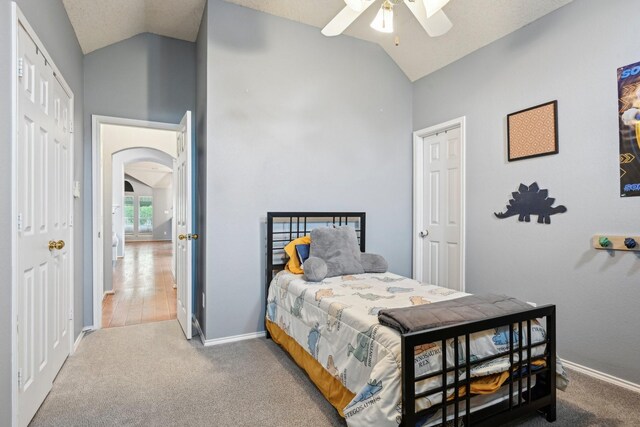 5729 Brazos Dr, Haltom City, TX 76137 - bedroom featuring carpet, baseboards, high vaulted ceiling, arched walkways, and a ceiling fan
