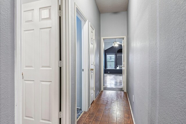 5729 Brazos Dr, Haltom City, TX 76137 - hallway featuring a textured wall, dark wood-style floors, and baseboards