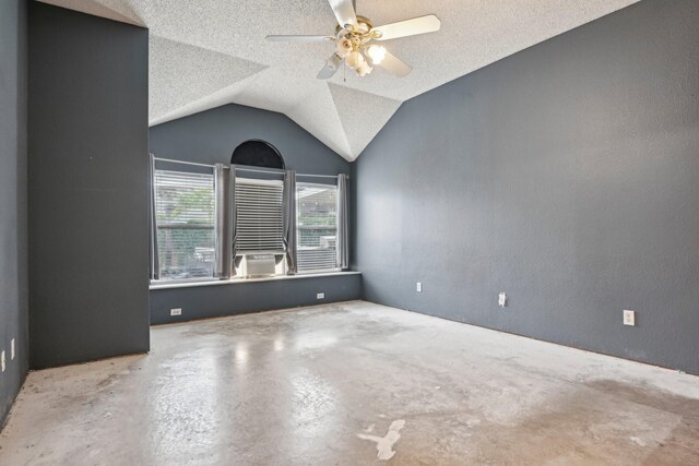 5729 Brazos Dr, Haltom City, TX 76137 - empty room with concrete flooring, a ceiling fan, vaulted ceiling, and a textured ceiling