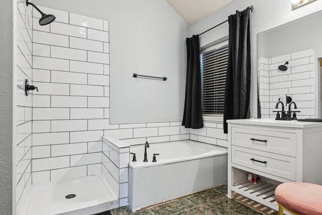 5729 Brazos Dr, Haltom City, TX 76137 - full bathroom featuring a shower stall, a garden tub, vanity, vaulted ceiling, and a textured ceiling