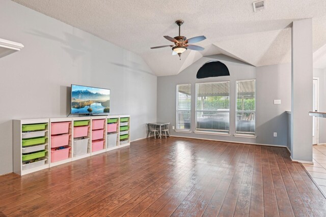 5729 Brazos Dr, Haltom City, TX 76137 - unfurnished living room featuring ceiling fan, wood-type flooring, a textured ceiling, vaulted ceiling, and baseboards