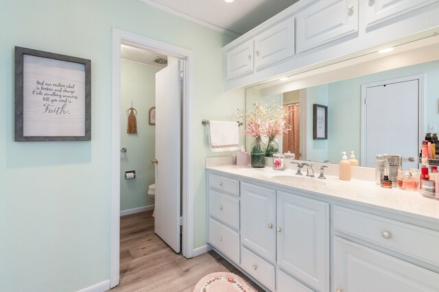 332 Azalea Dr, Sulphur Springs, TX 75482 - full bathroom with vanity, wood finished floors, toilet, crown molding, and baseboards